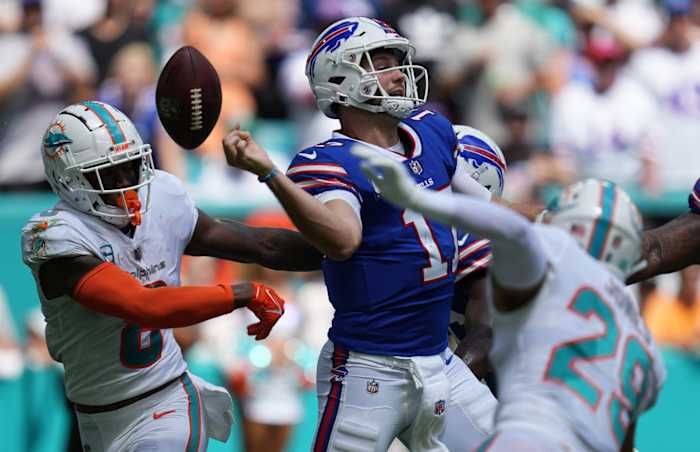 Buffalo Bills quarterback Josh Allen (17) fumbles after getting hit by Jevon Holland (8) of the Miami Dolphins during the first quarter of an NFL game at Hard Rock Stadium in Miami Gardens, Sept. 25, 2022.